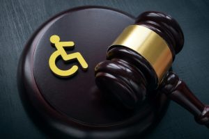 Image of a judge's gavel and international symbol of access (wheelchair figure) relevant to Disability Rights NSW.