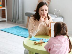 A speech therapist guiding a patient through speech exercises to improve vocal strength and communication clarity.