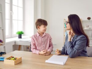 A speech therapist working with young children on speech exercises.