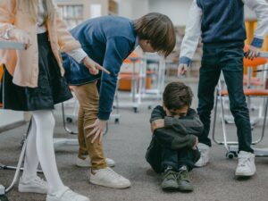 A boy being bullied, illustrating how phobias in childhood can develop due to early traumatic experiences.