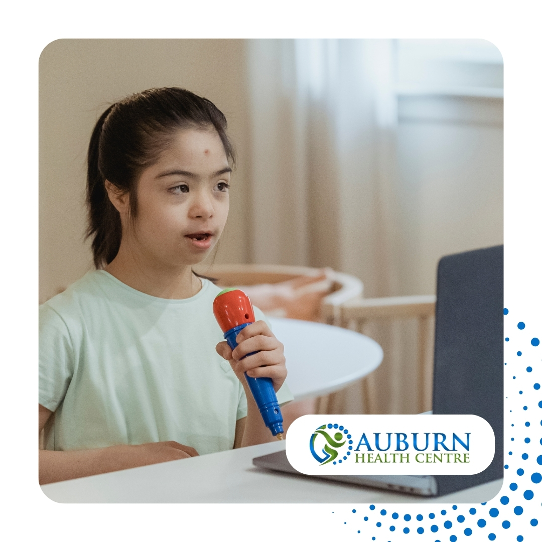 Young girl using a toy microphone during a virtual session for speech therapy for autism at Auburn Health Centre.